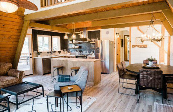 rustic log cabin in Acorn Falls, Bass Lake, California, featuring a cozy living room and a fully equipped kitchen—perfect for your next bass lake cabin rental getaway