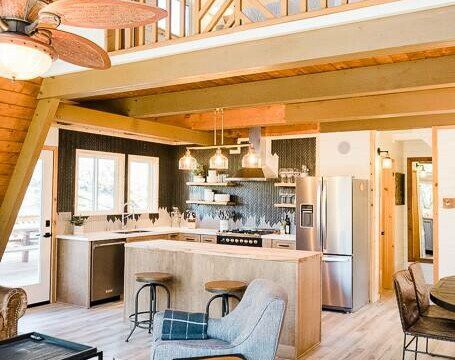 A lofted living area with wood floors and a ceiling fan in Bass Lake, California.