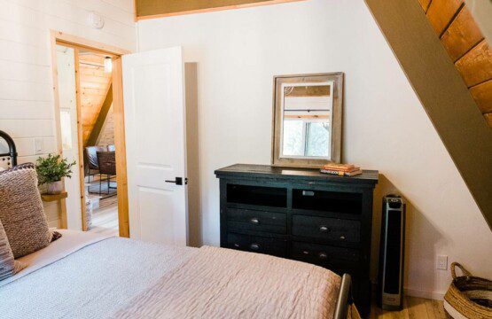Acorn Falls offers a cozy bedroom rental with a comfortable bed and a spacious dresser.