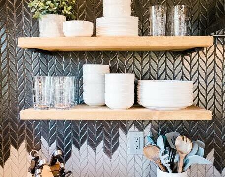A kitchen with a black and white herringbone tile backsplash located in Acorn Falls Bass Lake California