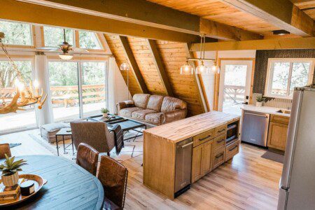 A kitchen and living room in a log cabin located in Acorn Falls Bass Lake California
