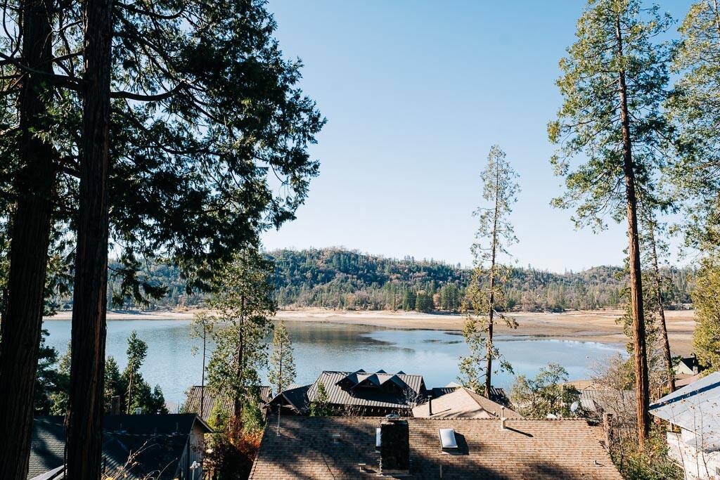 Overhead view of rooftops, river, and trees, perfect for a fall getaway at Bass Lake