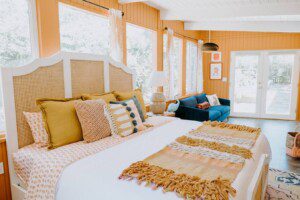 Spacious bedroom with a large cozy bed in a lake bungalow rental near Yosemite