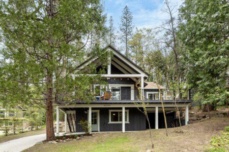 Rustic cabin near Bass Lake with wood paneling and rock fireplace