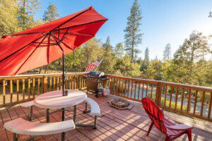 Cozy outdoor deck with patio seating at a book direct Bass Lake vacation rentals
