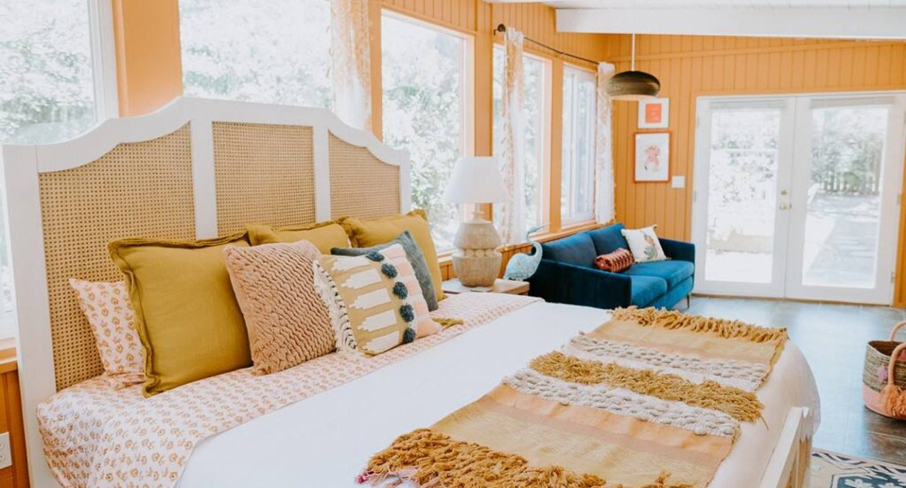 Spacious bedroom with a large cozy bed in a lake bungalow rental near Yosemite