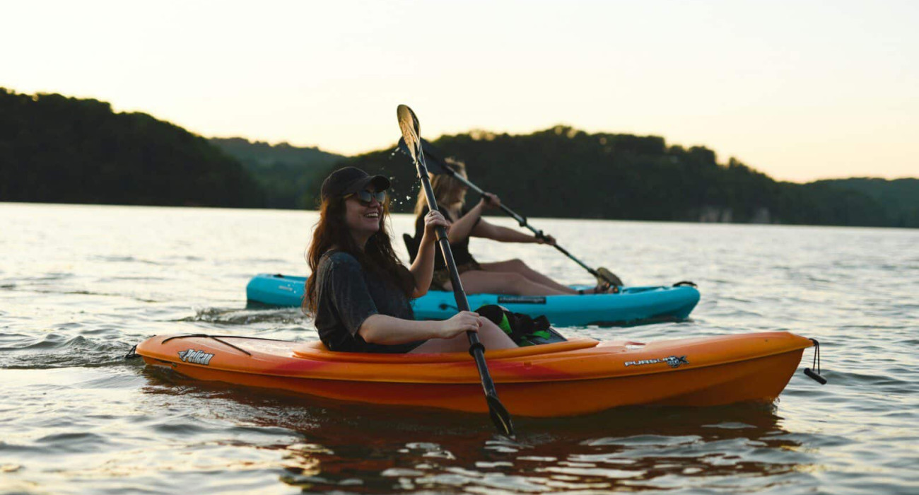 Two girls kayaking as part of Bass Lake water activities