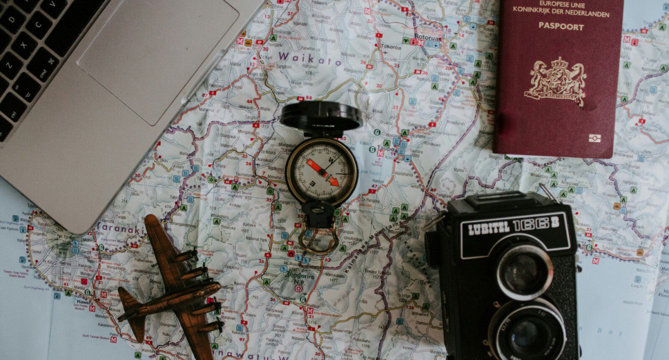 Yosemite multi-day itinerary preparation with travel essentials like map, camera, passport, and laptop for trip planning